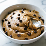 Bowl of gluten-free chocolate chip cookie dough with a spoon
